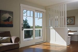 Renewal by Andersen off-white sliding door. Wood flooring in home
