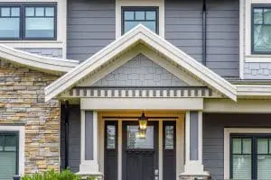 Should I Replace All My Doors at Once? A perfect neighborhood. Houses in suburb at Fall in the north America. Fragment of a luxury house with entrance door and nice window.
