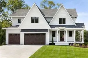 Luxurious home with dark brown doors and large black-frame windows.